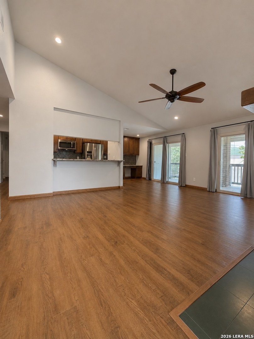 14343 Judson Road, Unit 302 San Antonio, TX 78233 - Photo 7 of 14 an empty room with wooden floor and windows
