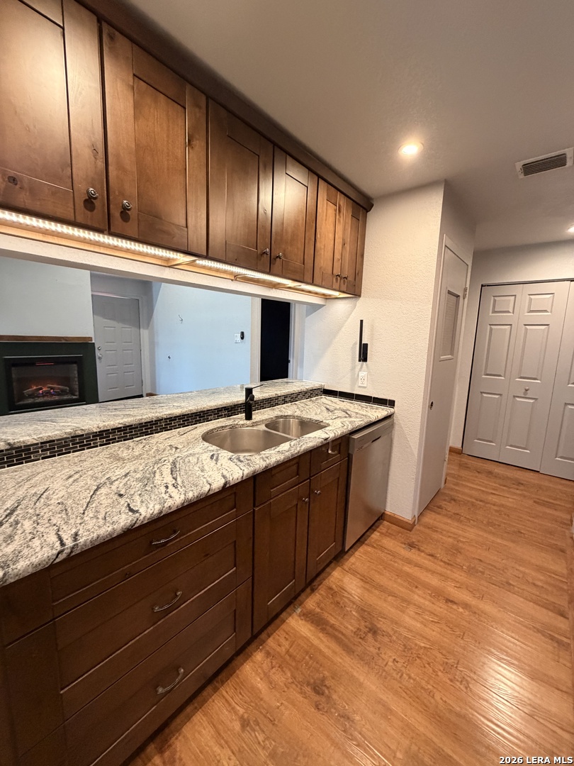 14343 Judson Road, Unit 302 San Antonio, TX 78233 - Photo 10 of 14 a large kitchen with granite countertop wooden cabinets and stainless steel appliances