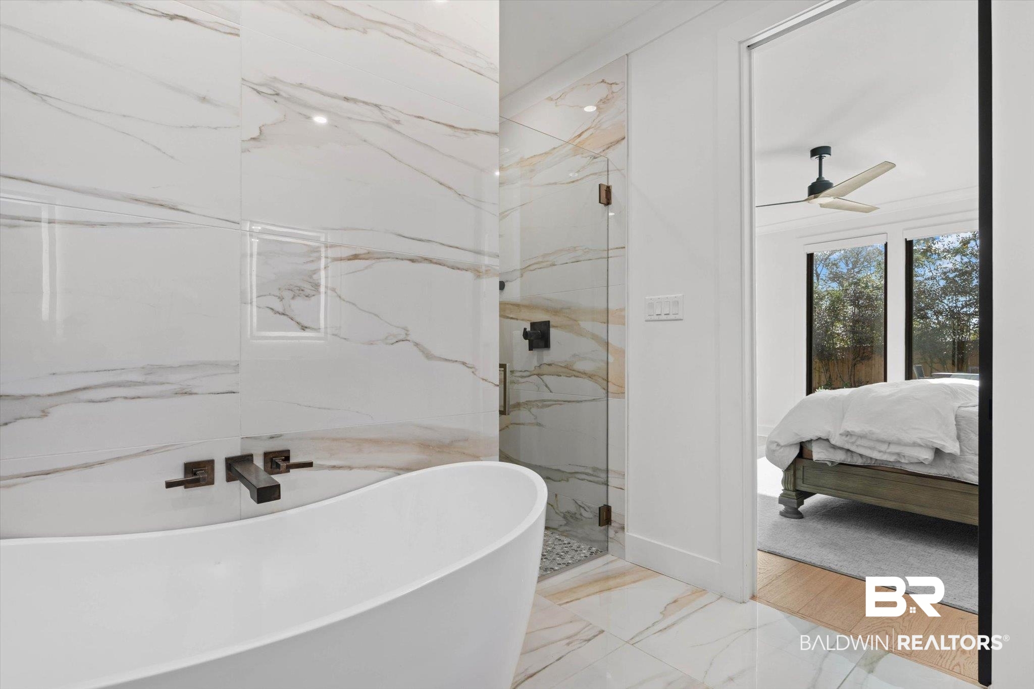 69 Jordan Lane Mobile, AL 36608 - Photo 23 of 57 Ensuite bathroom featuring a marble finish shower, a ceiling fan, a soaking tub, and light marble finish flooring