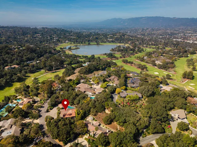 an aerial view of a houses with a lake