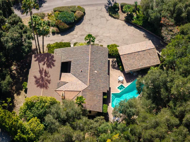 an aerial view of a house with a yard