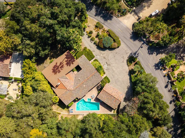 an aerial view of a house with a yard and lake view