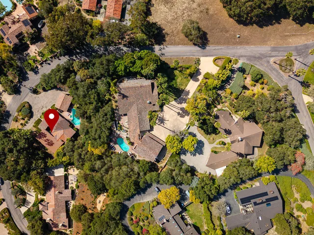 an aerial view of house with yard and parking