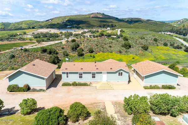 an aerial view of residential houses with outdoor space and river