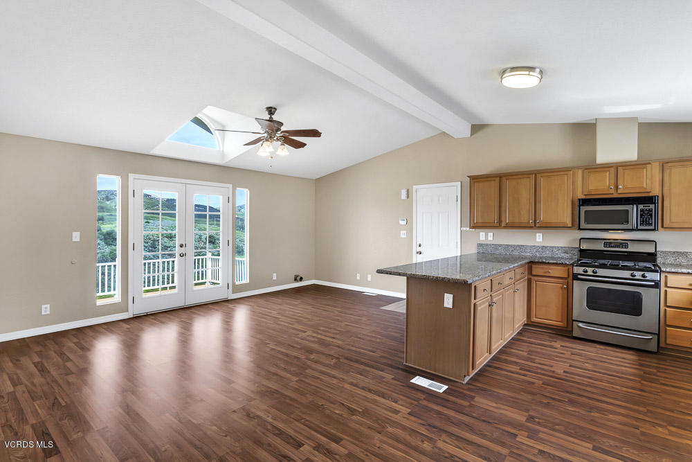 15535 LaPeyre Road Moorpark, CA 93021 - Photo 12 of 34 a large kitchen with wooden floors and stainless steel appliances