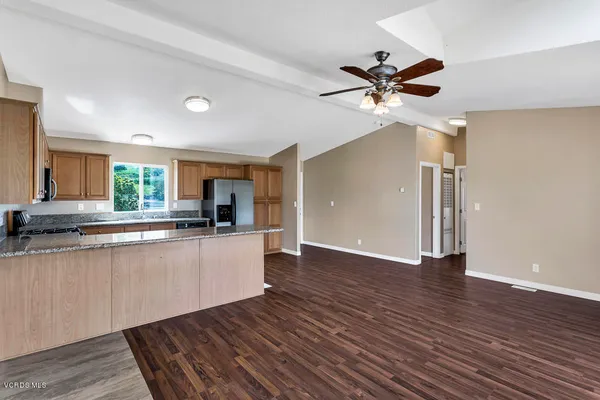 a view of a living room hardwood floor and a ceiling fan