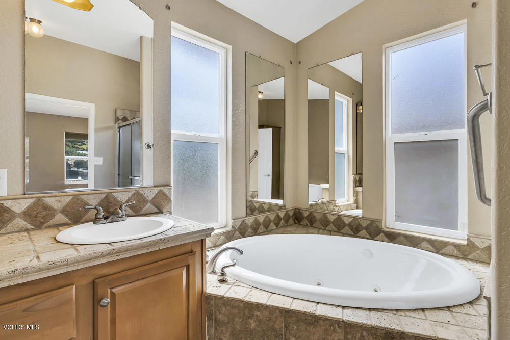 15535 LaPeyre Road Moorpark, CA 93021 - Photo 24 of 34 a bathroom with a tub sink and mirror