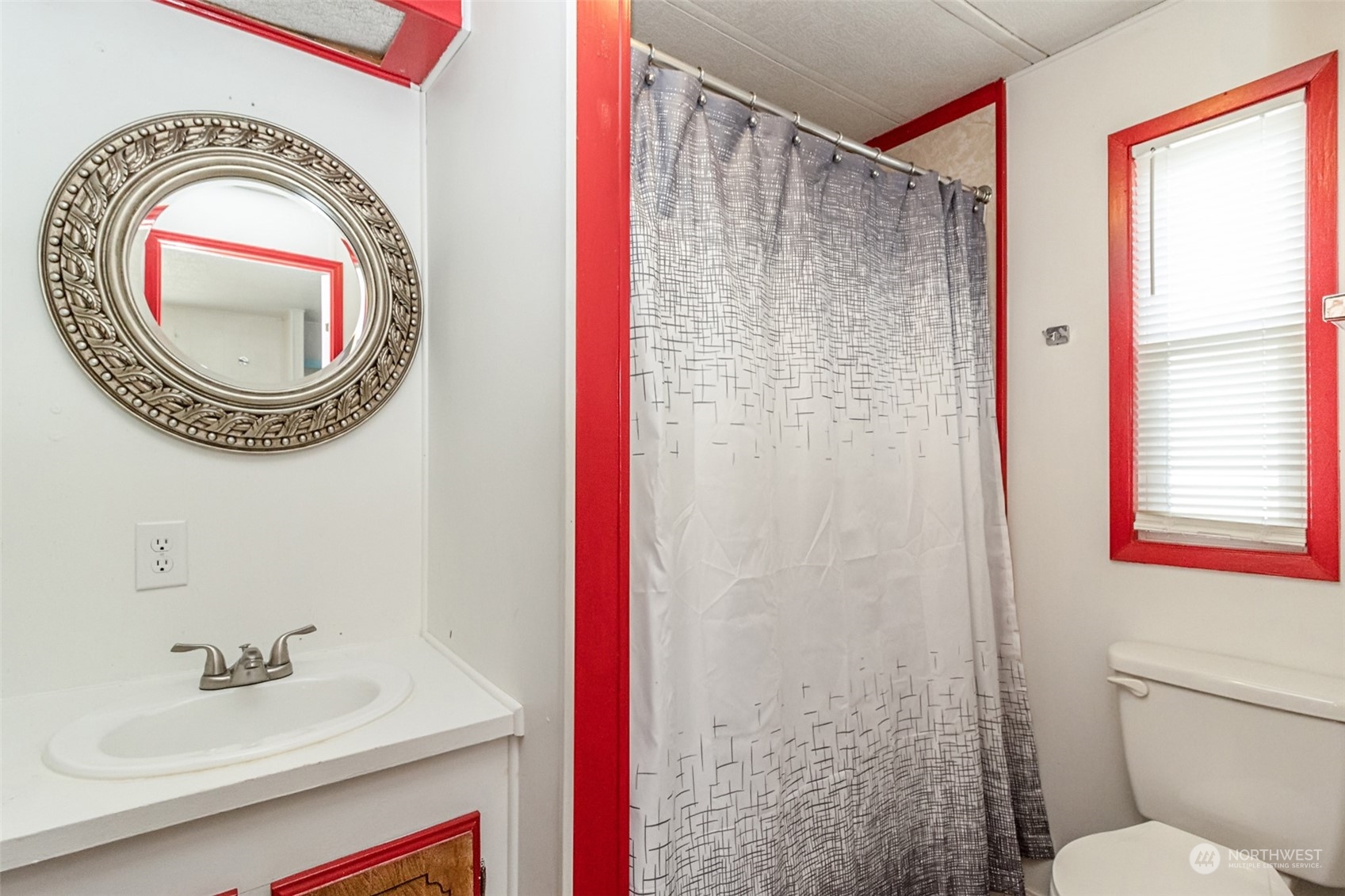 415 Lakeview Road, Unit E7 Lynnwood, WA 98087 - Photo 14 of 20 a bathroom with a sink a mirror and a toilet