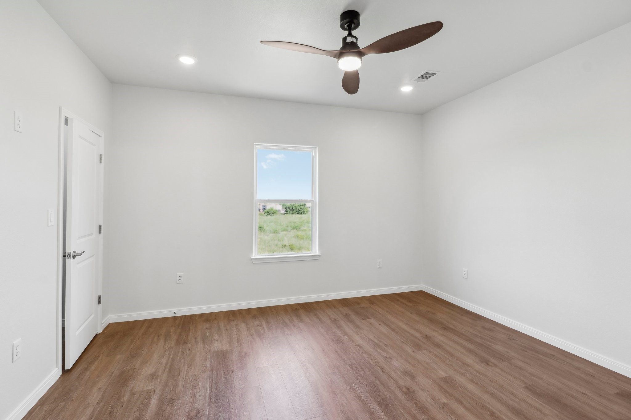 1326 Sapphire Palms Court San Leon, TX 77539 - Photo 11 of 20 an empty room with wooden floor and windows