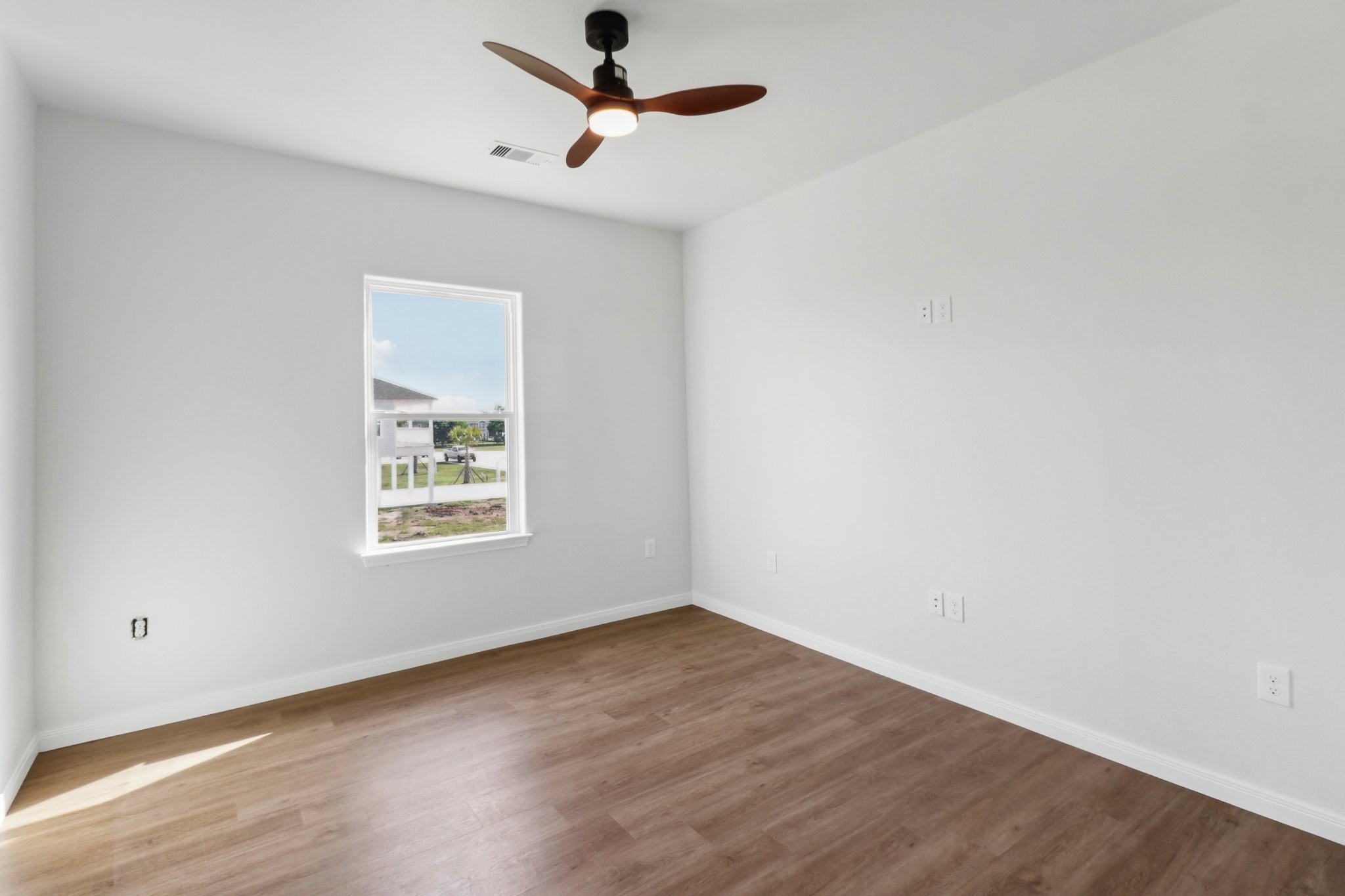 1326 Sapphire Palms Court San Leon, TX 77539 - Photo 14 of 20 an empty room with wooden floor ceiling fan and window