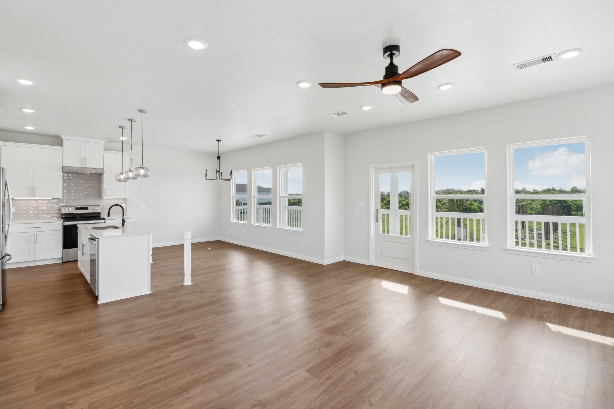 1326 Sapphire Palms Court San Leon, TX 77539 - Photo 10 of 20 a view of an empty room with wooden floor and a window