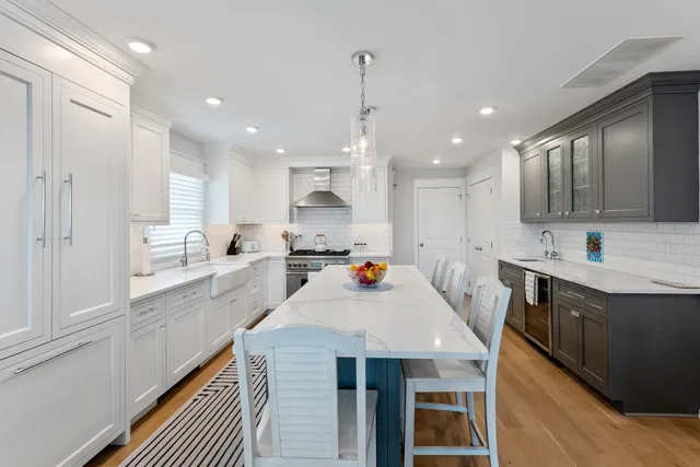 a kitchen with a sink stove and wooden cabinets