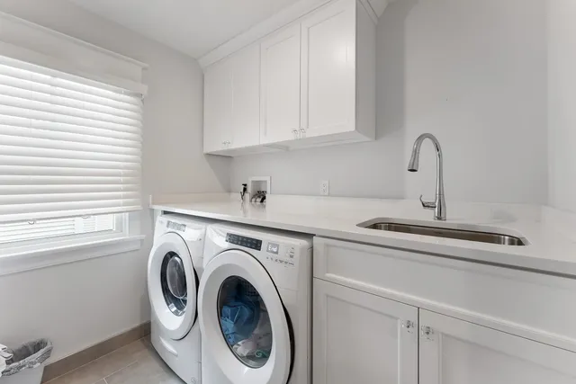 a view of a dining room with furniture and a chandelier