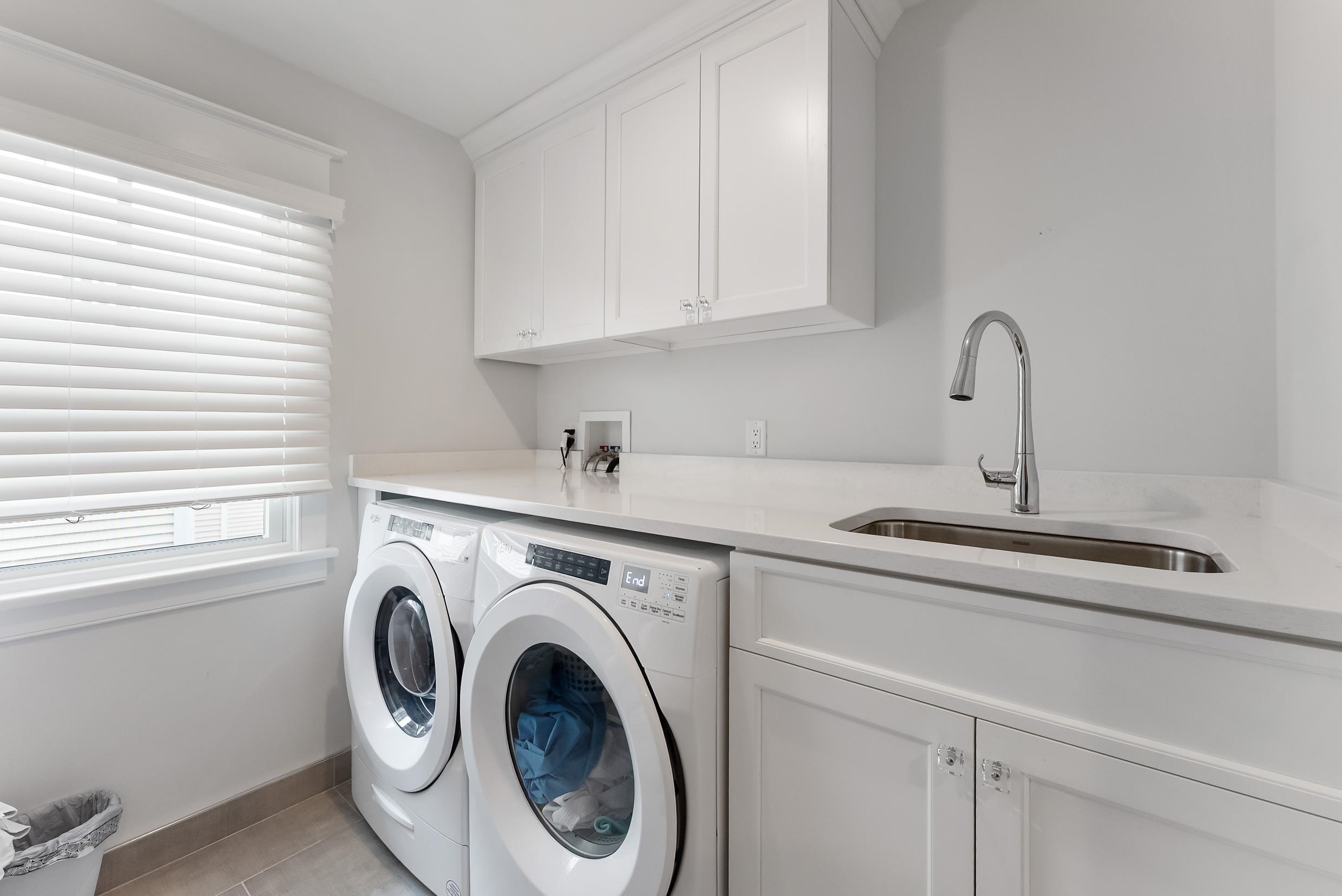 253 35th, Unit WEST Avalon, NJ 08202 - Photo 24 of 43 a utility room with sink dryer and washer