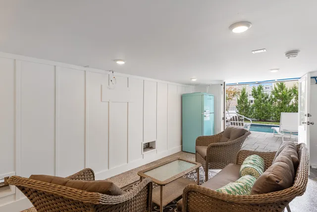 a view of a patio with couches table and chairs and potted plants