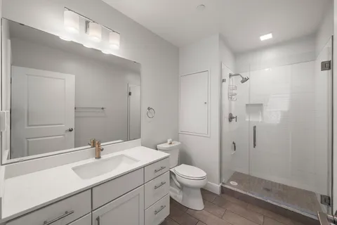 a bathroom with a sink toilet and shower