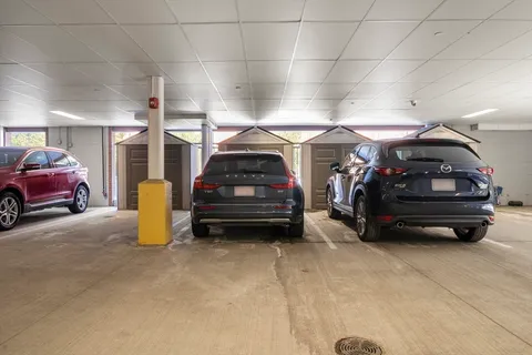 a view of parking garage with cars parked