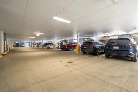 a view of parking space with parked cars