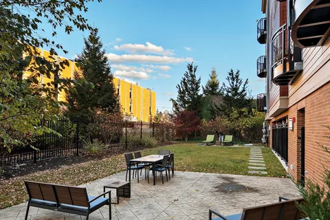 a view of a backyard with sitting area