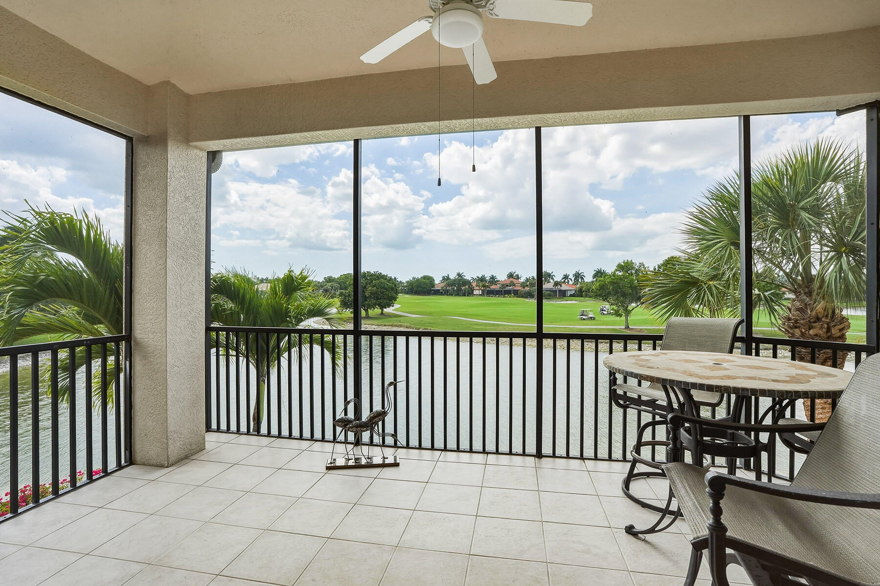 8605 Champions Point, Unit 103 Naples, FL 34113 - Photo 1 of 44 a view of a chairs and table in patio