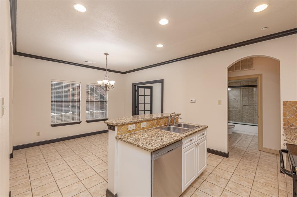 1871 Signal Ridge Place Rockwall, TX 75032 - Photo 8 of 26 a kitchen with granite countertop a sink and a stove top oven