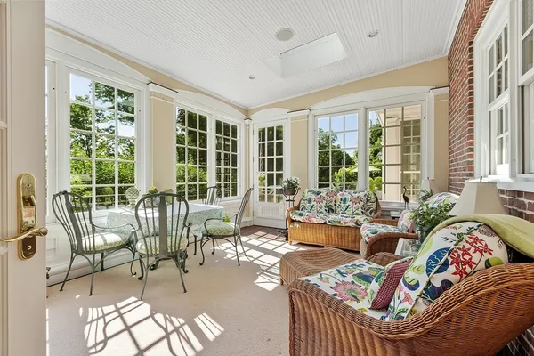 a living room with furniture and floor to ceiling windows