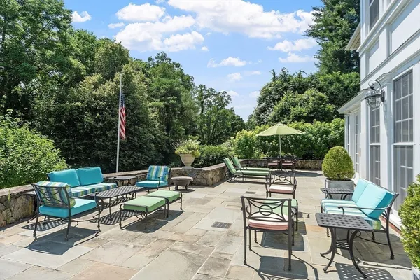 a view of backyard with outdoor seating and plants