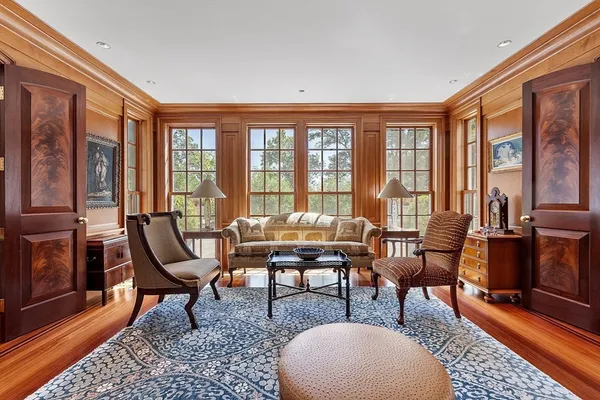 a living room with furniture and a floor to ceiling window