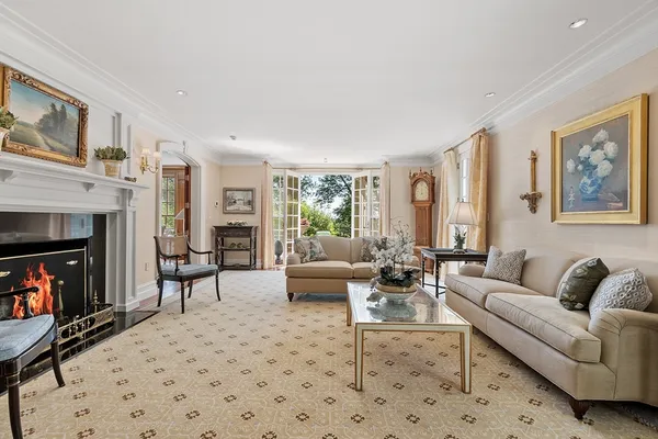 a living room with furniture large window and a fireplace