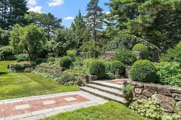 a view of a garden with an outdoor seating