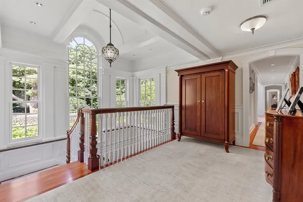 a bedroom with a bed mirror and window