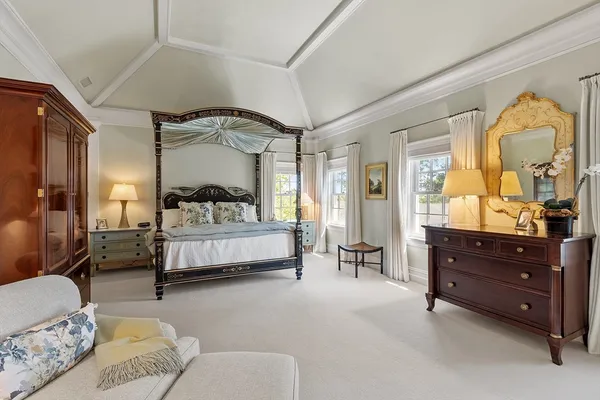 a bedroom with furniture fireplace and a chandelier