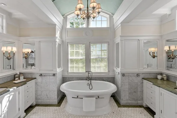 a living room with furniture kitchen view and a window