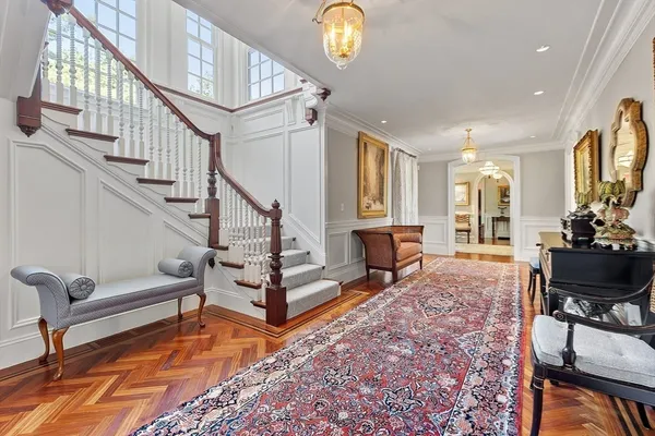 a living room with wooden floor and a dining table