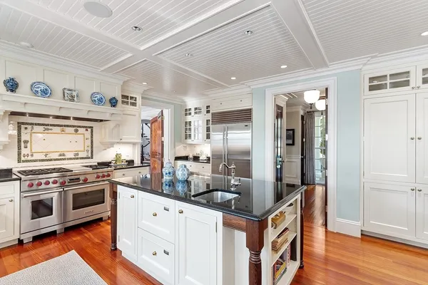 a kitchen with stainless steel appliances granite countertop a stove and a refrigerator