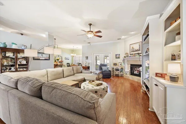 a living room with furniture fireplace and a chandelier