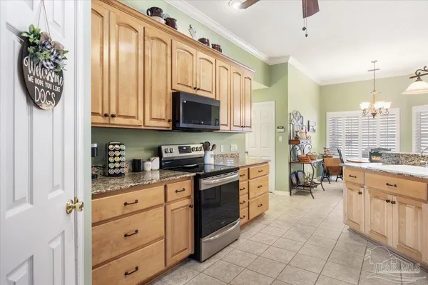 a kitchen with stainless steel appliances a sink window and cabinets