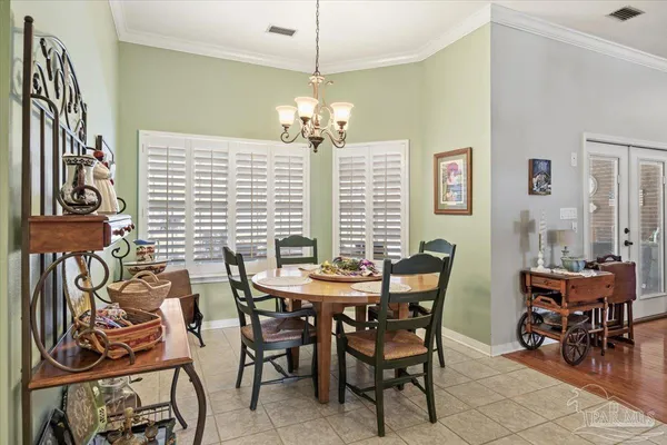 a view of a dining room with furniture and chandelier