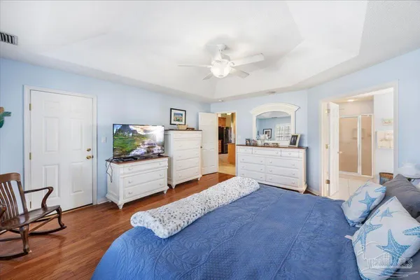 a large white kitchen with cabinets