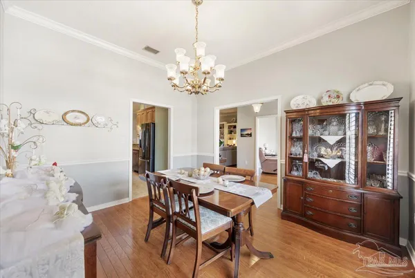 a view of a dining room with furniture and chandelier
