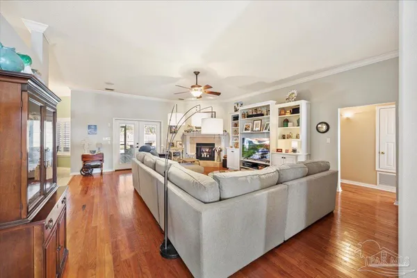 a living room with furniture a fireplace and wooden floor