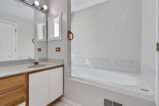 1822 Olde Mill Road Plainfield, IL 60586 - Photo 11 of 29 a bathroom with a granite countertop sink mirror and a bathtub