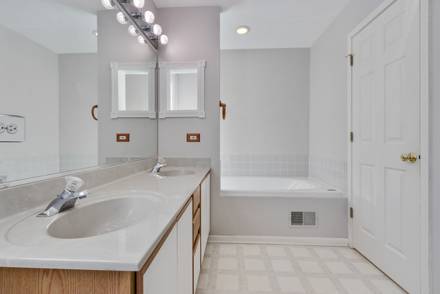 1822 Olde Mill Road Plainfield, IL 60586 - Photo 12 of 29 a bathroom with a sink a toilet and shower