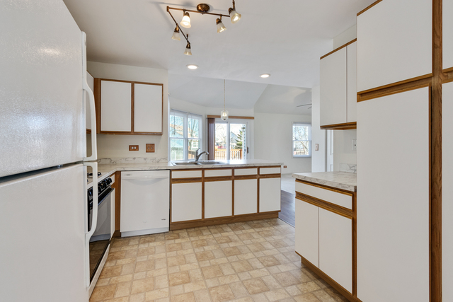 1822 Olde Mill Road Plainfield, IL 60586 - Photo 17 of 29 a kitchen with a refrigerator a sink and cabinets
