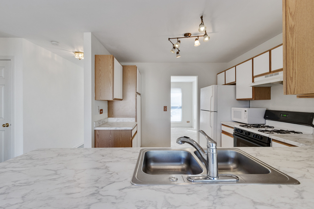 1822 Olde Mill Road Plainfield, IL 60586 - Photo 21 of 29 a kitchen with a refrigerator and a sink