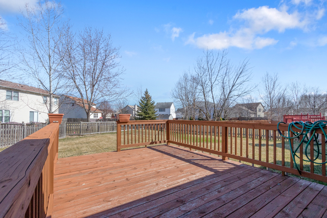1822 Olde Mill Road Plainfield, IL 60586 - Photo 25 of 29 a view of deck with wooden floor and fence with a barbeque