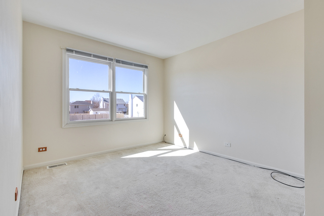 1822 Olde Mill Road Plainfield, IL 60586 - Photo 4 of 29 a view of an empty room with a window