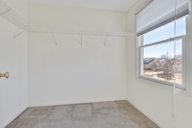 1822 Olde Mill Road Plainfield, IL 60586 - Photo 7 of 29 a view of a small space with wooden floor and a window