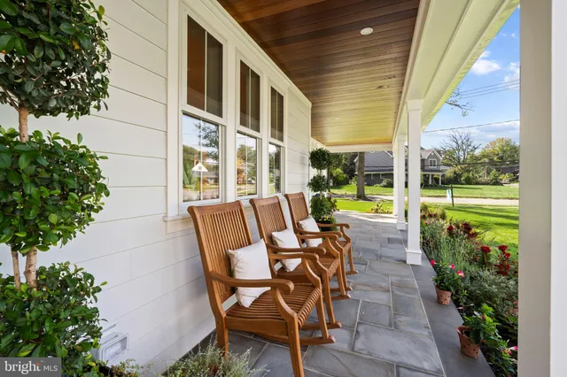 a view of an chairs and tables in the patio with a yard