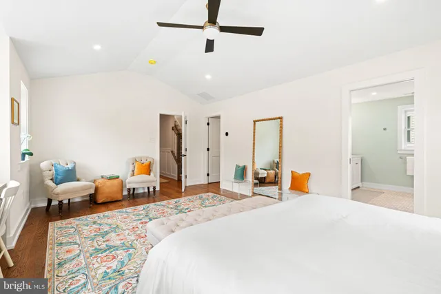 a bedroom with a bed and a wooden floor